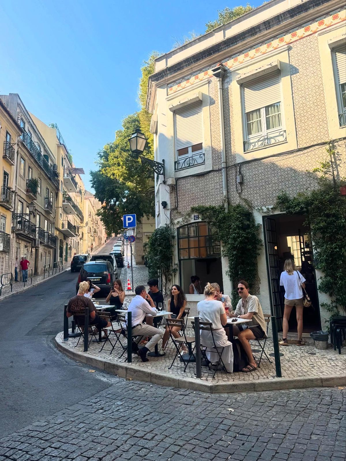 Street view of Príncipe Real Lisbon with Tagus river in background